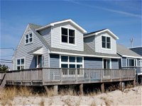 Brant Beach Ocean Front home. Hardwood and tile flooring wrap around deck on the ocean from 1st floor bedroom 47072